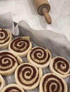 several cinnamon rolls sitting on top of a pan