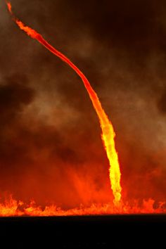 a large red object is flying in the air with it's tail spewing out