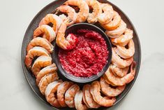 a plate with shrimp and cranberry sauce on it, ready to be eaten