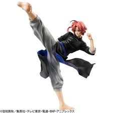 an action figure is posed in the air with his legs spread out and one leg up