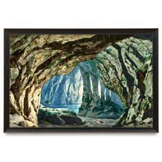 an image of a cave with rocks and water in the foreground, framed in black wood