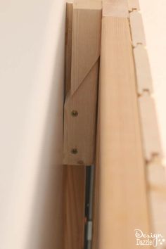 a close up of a wooden frame with screws