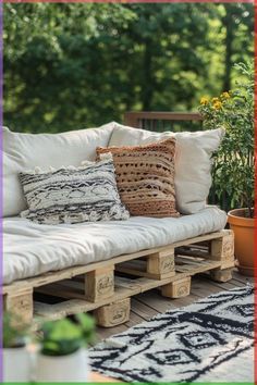 a couch made out of wooden pallets on a patio with plants in the background