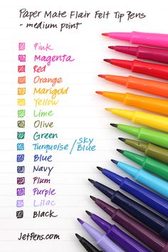 several different colored pens lined up on top of each other in front of a white sheet of paper