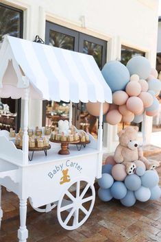 a baby care cart with balloons and teddy bears on the front porch for desserts