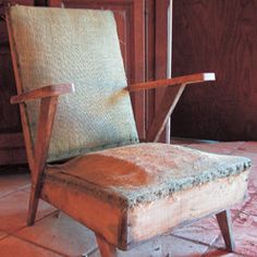 an old chair sitting in front of a wooden door