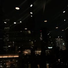 the city lights shine brightly in the dark night sky above some buildings and skyscrapers