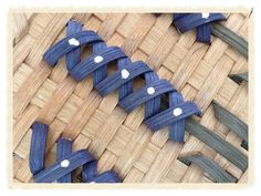 two pairs of blue sandals sitting on top of a woven mat