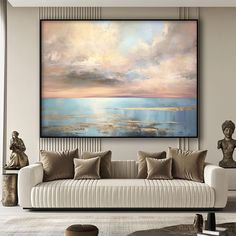 a living room scene with focus on the couch and large painting hanging above it's head