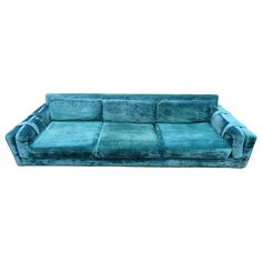 a blue couch sitting on top of a white floor