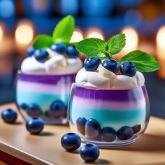 two dessert cups with blueberries and whipped cream