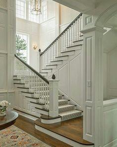 a white staircase leading up to the second floor