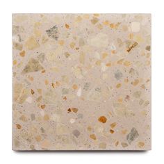 a square tile with gold and white speckles on the bottom, against a white background