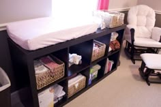 a baby's room with a crib, rocking chair and bookshelf