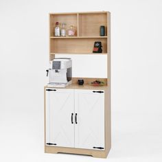 a wooden shelf with two doors and some cupboards on the top one has a coffee maker