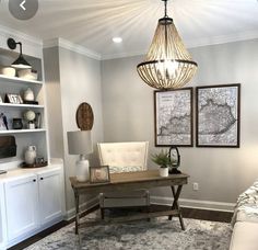 a living room filled with furniture and a chandelier hanging over the top of it