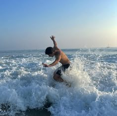 a man riding a wave on top of a surfboard