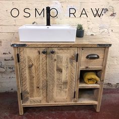 a wooden cabinet with a white sink and black faucet