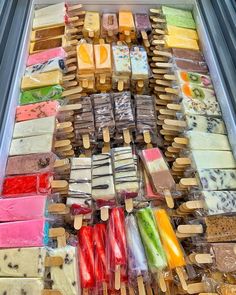 an assortment of different types of popsicles on sticks