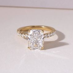 an engagement ring with a cushion cut diamond