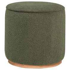 a green stool with wooden legs and a round cushion on the top, in front of a white background