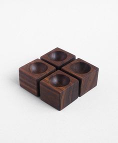 four wooden cubes sitting on top of each other in front of a white background