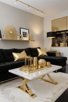 a living room filled with black furniture and gold accents