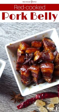 red cooked pork belly in a white square bowl with spices and cinnamon on the side