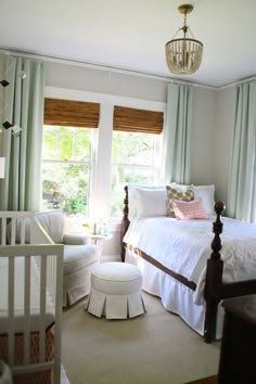 a baby's room with a crib, rocking chair and bed