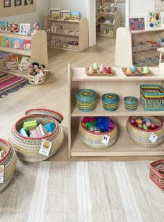 a child's playroom with toys and baskets on the floor