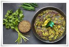 a pan filled with food next to some green vegetables