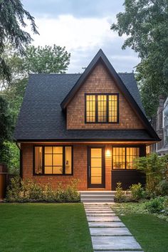 a house with a walkway leading up to the front door and windows on each side