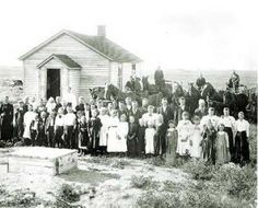 an old black and white photo of people standing in front of a building