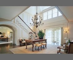 an elegant living room with chandelier and piano