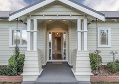 the front entrance to a house with white trim