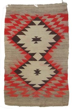 an old navajo rug with red, white and brown colors