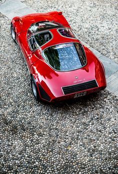 a red sports car is parked on the street