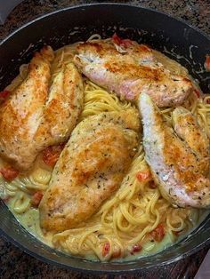 some chicken and pasta in a pan on the stove