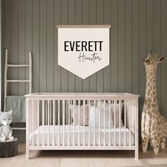 a baby's room with a white crib and two giraffes