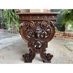 an ornately carved wooden planter sits on the sidewalk