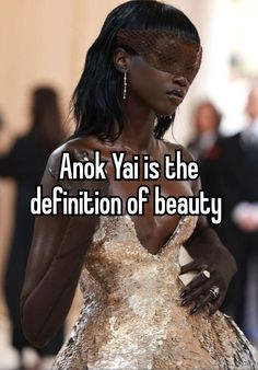 a woman in a gold dress with the words anok yai is the definition of beauty