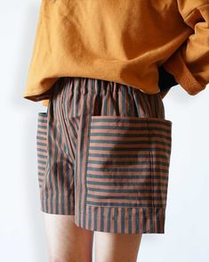 a person wearing shorts with stripes on them