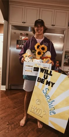 a woman holding a sign with sunflowers on it