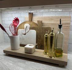 an assortment of kitchen utensils on a wooden tray