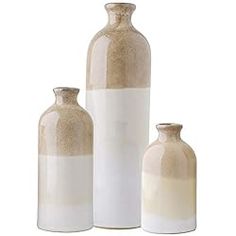 three white vases sitting next to each other