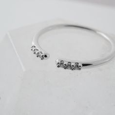 A slim, smooth open ring, detailed with 3 dainty crystals at each end. A classic silhouette that's gorgeous when worn solo or the perfect compliment when stacked with more rings. Size: 5.5 - 7.5 (slightly adjustable). AAA-rated cubic zirconia crystals. Our materials make for an amazing, high quality, seamless, jewelry piece with longevity. Our rings are plated with 18k gold, 18k rose gold, or sterling silver and finished with a protective coating. A little secret we’ll keep between us: it looks Textured Ring, Knuckle Rings, Between Us, Open Ring, Classic Silhouette, Pearl Ring, 18k Rose Gold, Rose Gold Ring, Ring Sets