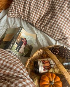 an image of a bed setting with books and pumpkins