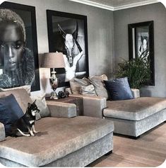 a living room with couches and pictures on the wall