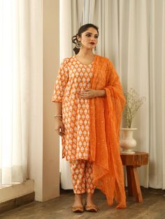 Beautiful handcrafted straight kurta pants set in pure cotton with lovely matching cotton doriya dupatta that is rightly finished with mirror embroidery. Color: Orange Fabric: Cotton and Kota Doria Note: Length and sizes can be customised Length - Kurta 40 inches Pants 38 inches Available in other colors If you happen to see some deformity in hand-work or fabric, that’s mere the technique of the same and not a defect. The garment is quite premium. The product will be delivered within 20-25 days Orange Chikankari Embroidery Palazzo Set For Diwali, Orange Anarkali Set With Gota Work, Straight Kurta, Diwali Orange Chikankari Embroidery Palazzo Set, Orange Embroidered Palazzo Set With Straight Kurta, Orange Palazzo Set With Dabka Work And Straight Kurta, Straight Kurta In Cotton Silk With Mirror Work, Straight Cotton Silk Kurta With Mirror Work, Mirror Work Mulmul Anarkali Set With Straight Kurta, Semi-stitched Cotton Sharara With Gota Work