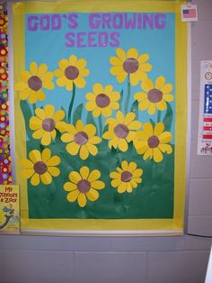 a bulletin board with yellow daisies in front of a blue background that says god's growing seeds